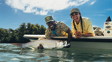 Young woman and man fishing in Columbia outerwear